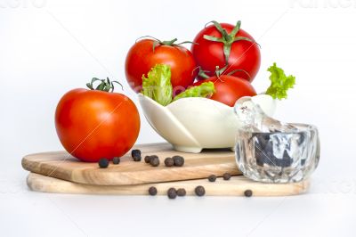 Red juicy tomatoes, lettuce leaves and black pepper