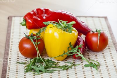 Tomatoes, leaves of arugula and sweet pepper