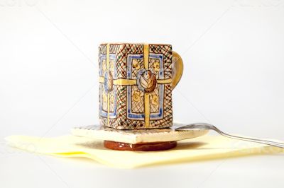 Ceramic coffee cup with a square saucer