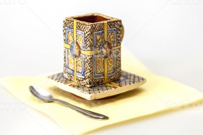 Ceramic coffee cup with a square saucer