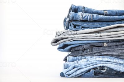 Pile of jeans of various colors