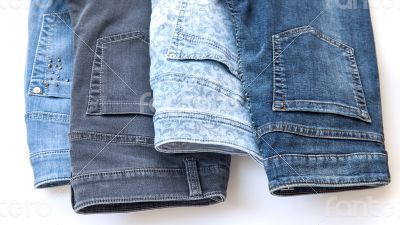 jeans of various colors on a counter in shop