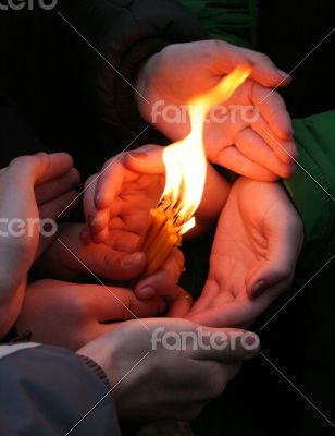 Flaming candle upon palms protection