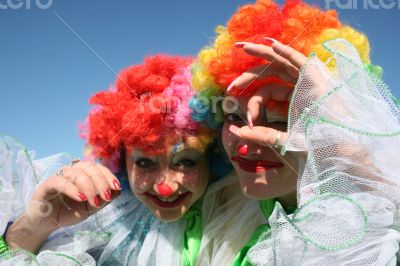 Two bizarre clowns in colored wigs