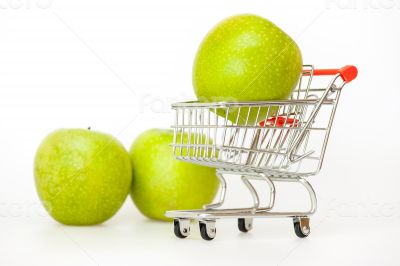 Large green apples in the cart for shopping