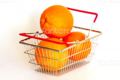 Bright large oranges in a basket for shopping