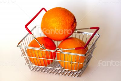 Bright large oranges in a basket for shopping