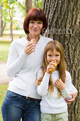 Mother and daughter eating