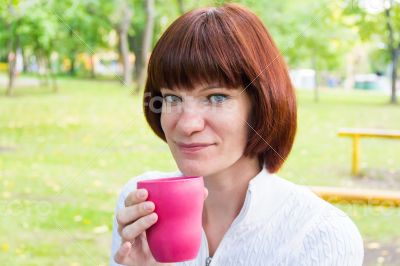 Woman with brown hair drinking tea