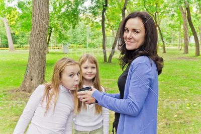 Woman with two girls drinking tea