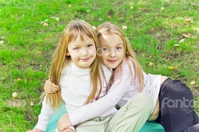 Two girls sitting on grass