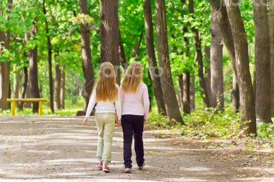 Cute two girls walking in park
