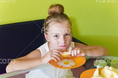 Cute girl eating melon