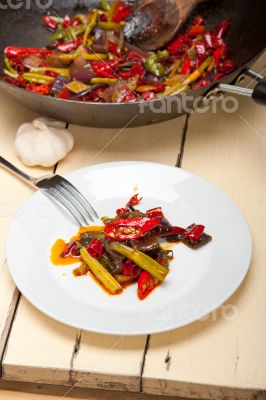fried chili pepper and vegetable on a wok pan