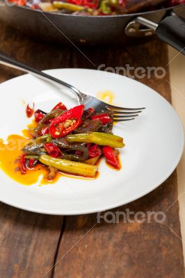 fried chili pepper and vegetable on a wok pan