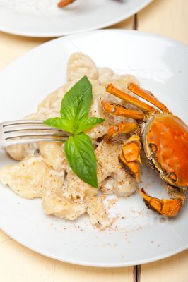 Italian gnocchi with seafood sauce with crab and basil