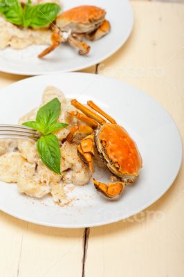 Italian gnocchi with seafood sauce with crab and basil