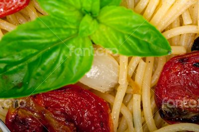 spaghetti pasta with baked cherry tomatoes and basil 