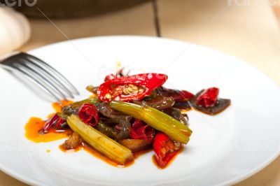 fried chili pepper and vegetable on a wok pan