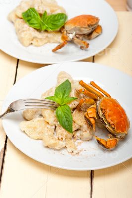 Italian gnocchi with seafood sauce with crab and basil