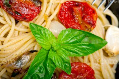 spaghetti pasta with baked cherry tomatoes and basil 