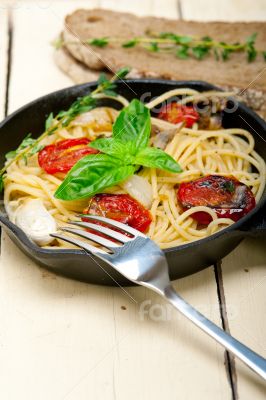 spaghetti pasta with baked cherry tomatoes and basil 