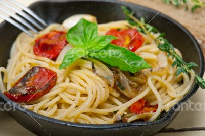spaghetti pasta with baked cherry tomatoes and basil 