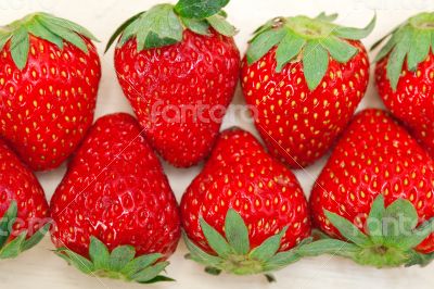 fresh organic strawberry over white wood