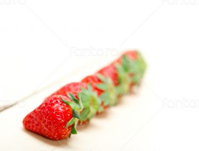 fresh organic strawberry over white wood