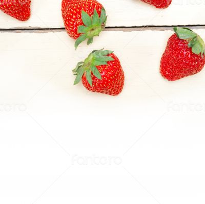 fresh organic strawberry over white wood