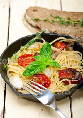 spaghetti pasta with baked cherry tomatoes and basil 