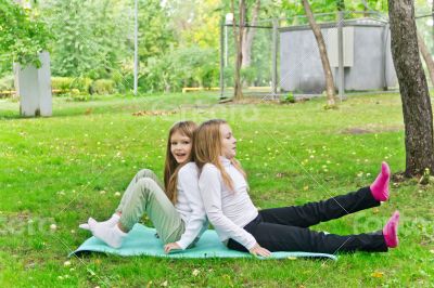 Two girls sitting on grass