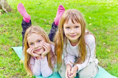Two girls sitting on grass