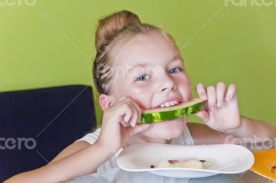 Cute girl eating watermelon