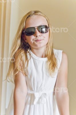 Cute girl playing with sunglasses