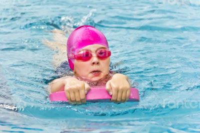 Cute girl in swimming pool