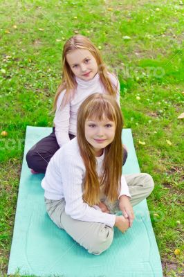 Two girls sitting on grass