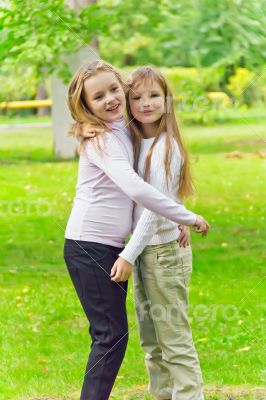 Cute two embracing girls