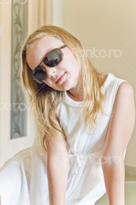 Cute girl playing with sunglasses
