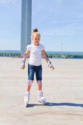 Cute girl on roller skates in summer