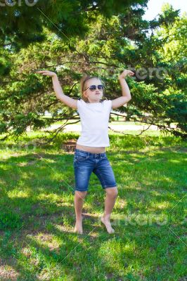 Cute dancing girl in sunglasses