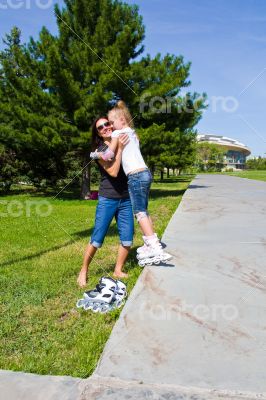 Learning mother and daughter on roller skates