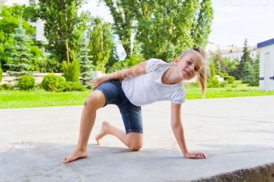 Cute girl draws chalk on asphalt