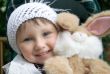 Small smiling girl with plush toy.