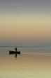 Lonely boat on silent water. sunset