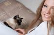 beautiful smiling girl in white with cat