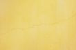 yellow stucco with crack