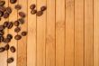 Grains of coffee on a carpet made of a bamboo