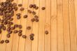 Grains of coffee on a carpet made of a tree