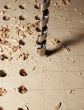 Drilling of apertures in a sheet of plywood